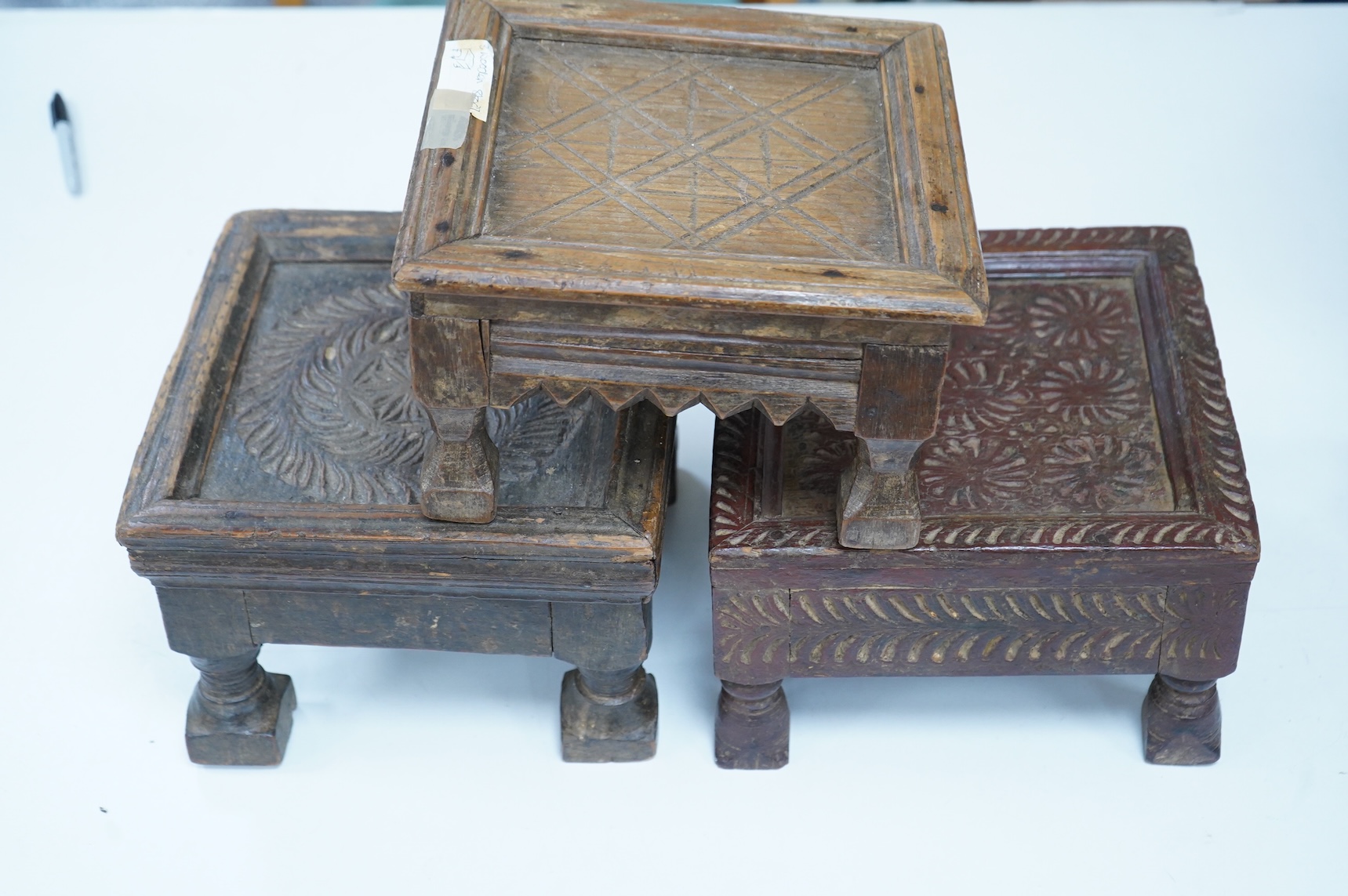 Three Indian carved wood stools or small tables, largest 27cm wide